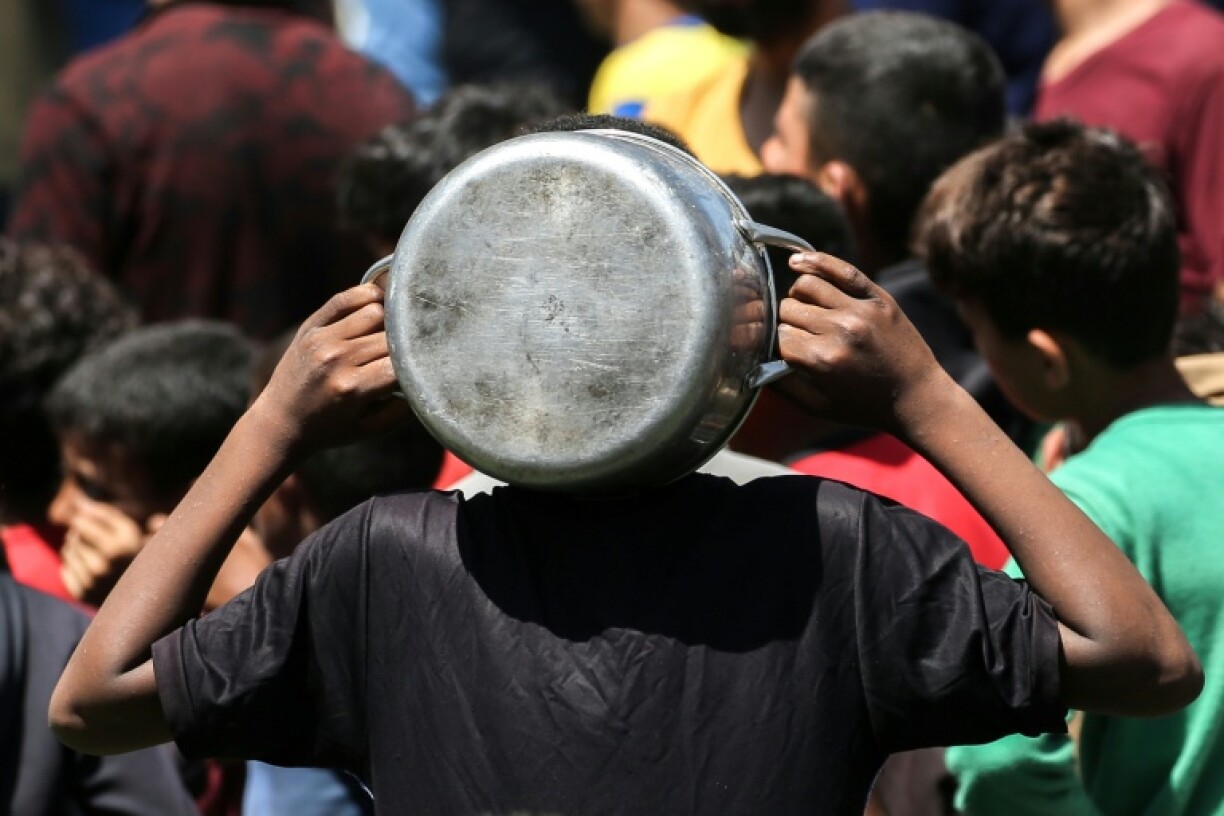 Palestinians gather at a food kitchen in Nuseirat refugee camp in central Gaza.
