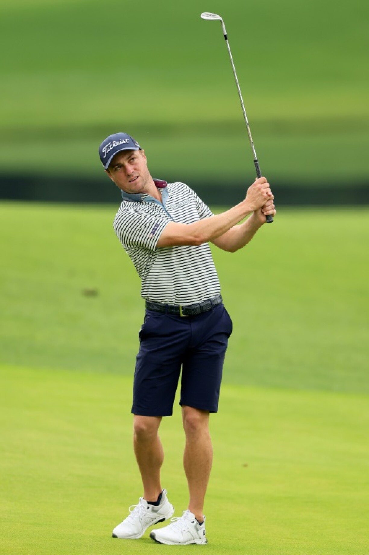 Two-time major winner Justin Thomas of the United States hits a chip shot in a practice round ahead of the 107th PGA Championship at Quail Hollow