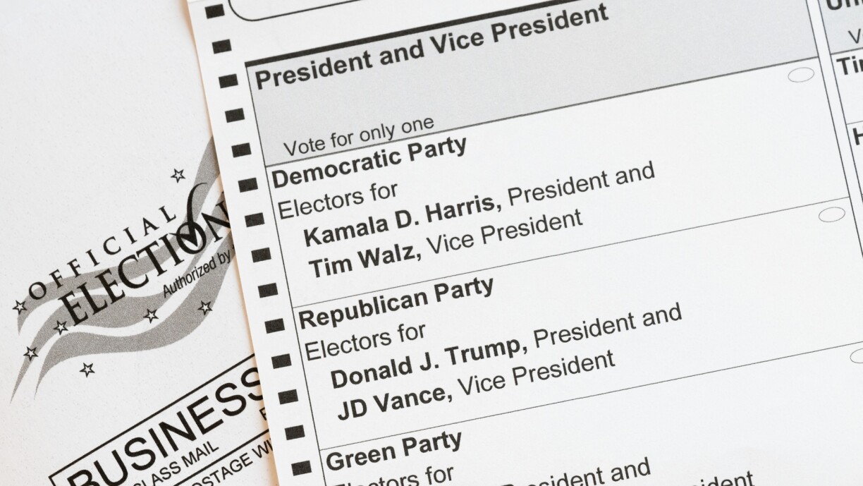 In this photo illustration, an absentee voter mail-in ballot shows the names of the presidential and vice presidential candidates for the US presidential election, in Arlington, Virginia, on 25 September 2024.