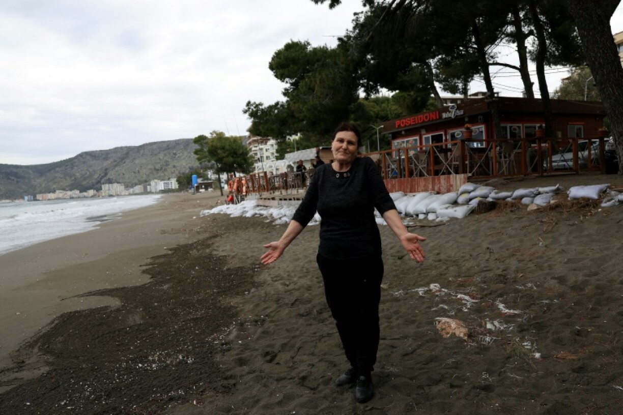 Vera Faslliaj's beachfront restaurant has been shored up with sandbags