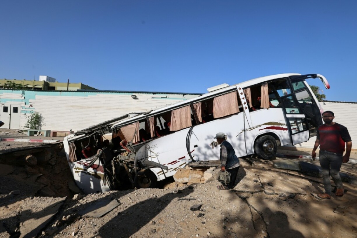 An Israeli air strike in the south Gaza city of Khan Yunis leaves a crater that pulls in a bus.
