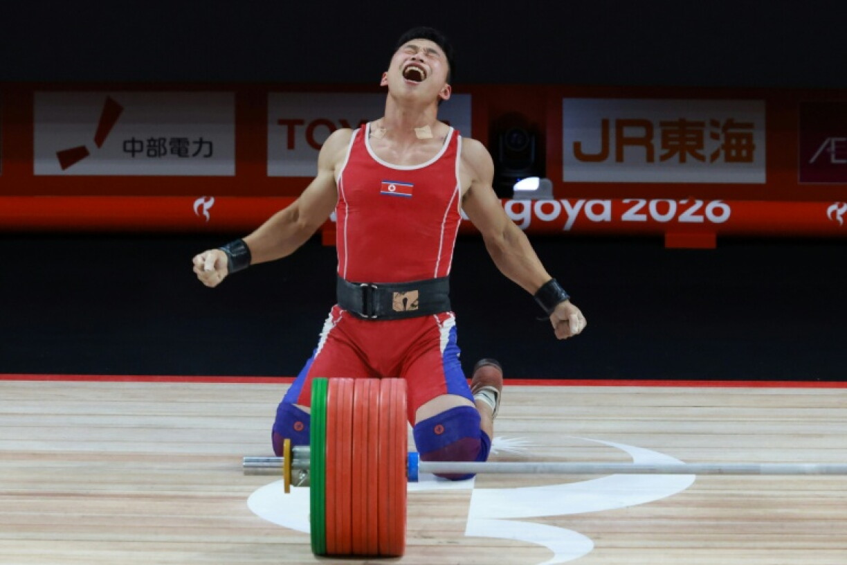 North Korea's Ri Won Ju celebrate sgold and a wrod record in the 70kg men's weightlifting at the Asian Games in Nagoya