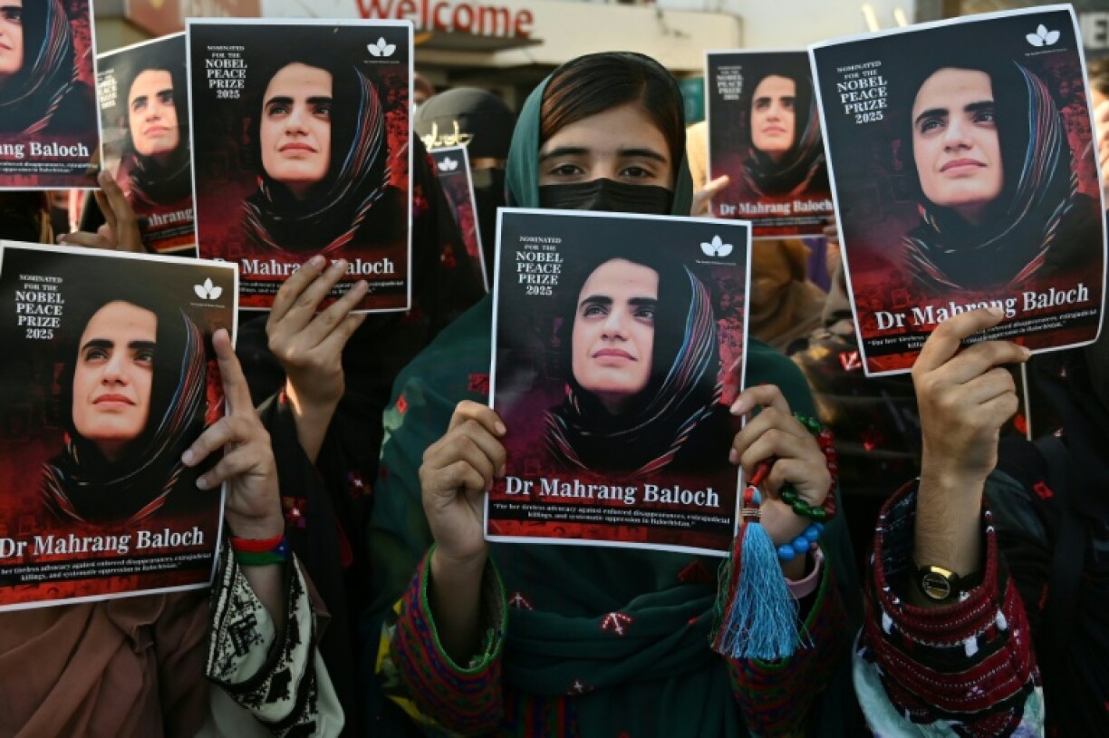 Activists from the Baloch Unity Committee hold portraits of Mahrang Baloch, one of Pakistan's most prominent human rights advocates