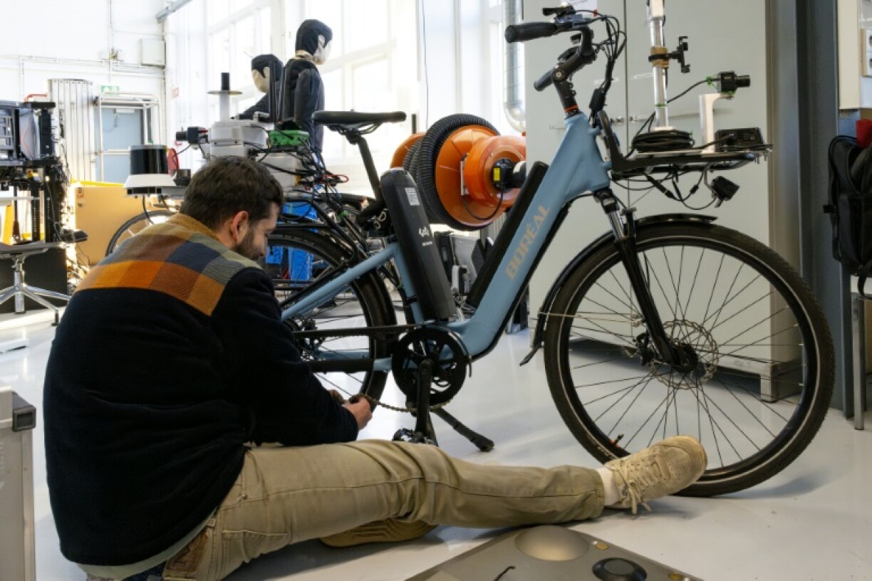A robotics student at Delft University of Technology works on a TU Delft SenseBike