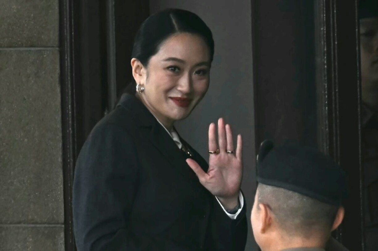 Paetongtarn Shinawatra waves as she arrives at Government House in Bangkok on August 29