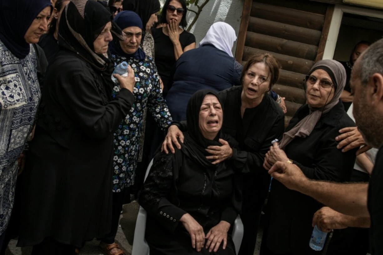 The mother of a victim of an Iranian missile attack that hit the Arab town on Tamra in northern Israel, during the funeral