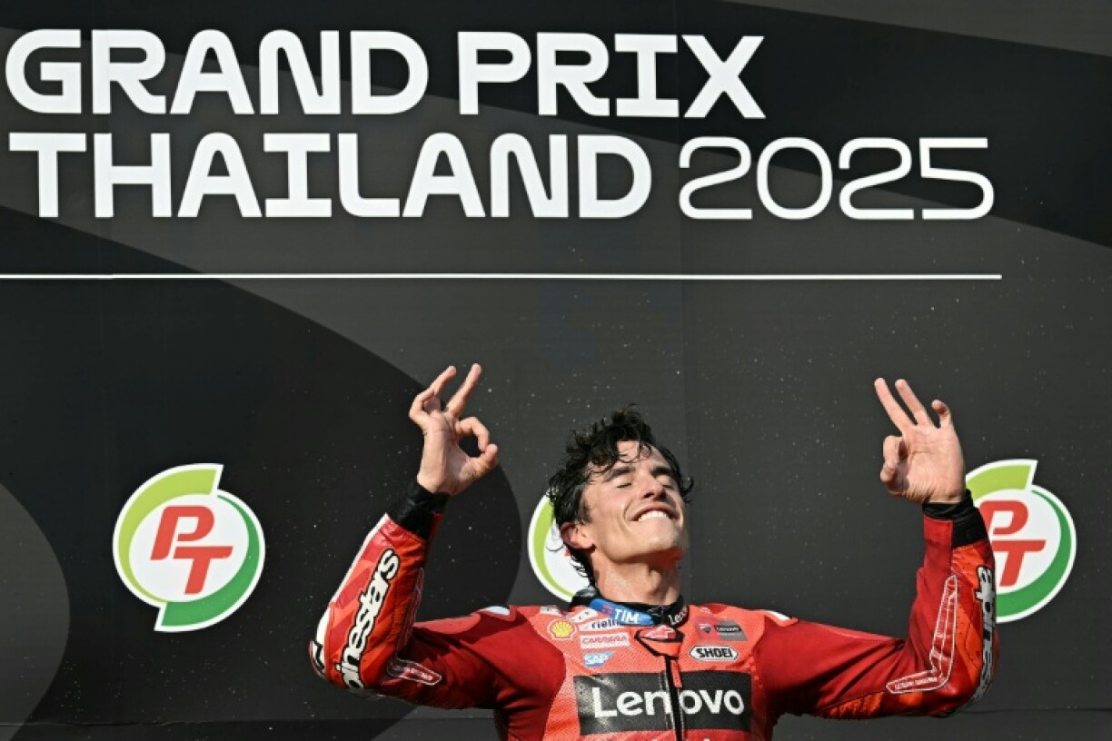Ducati Lenovo's Spanish rider Marc Marquez celebrates on the podium after winning the Thia MotoGP