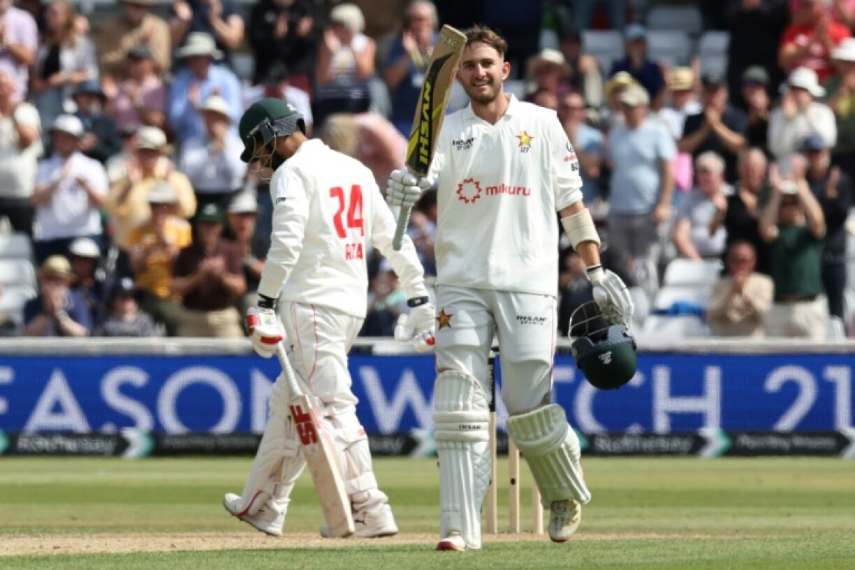 Zimbabwe's Brian Bennett celebrates reaching his century in a one-off Test against England at Trent Bridge