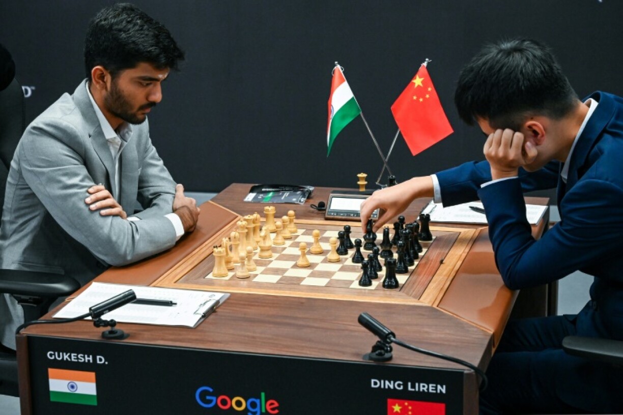 China's chess grandmaster Ding Liren (R) and Indian grandmaster Gukesh Dommaraju remain tied, with both on 4.0 after eight games in the World Championship