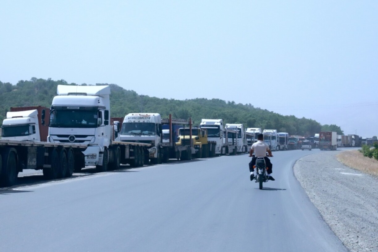 Trucks queue at the Bashmakh border crossing in Iraq, where some Iranian drivers described shortages of staple goods back home