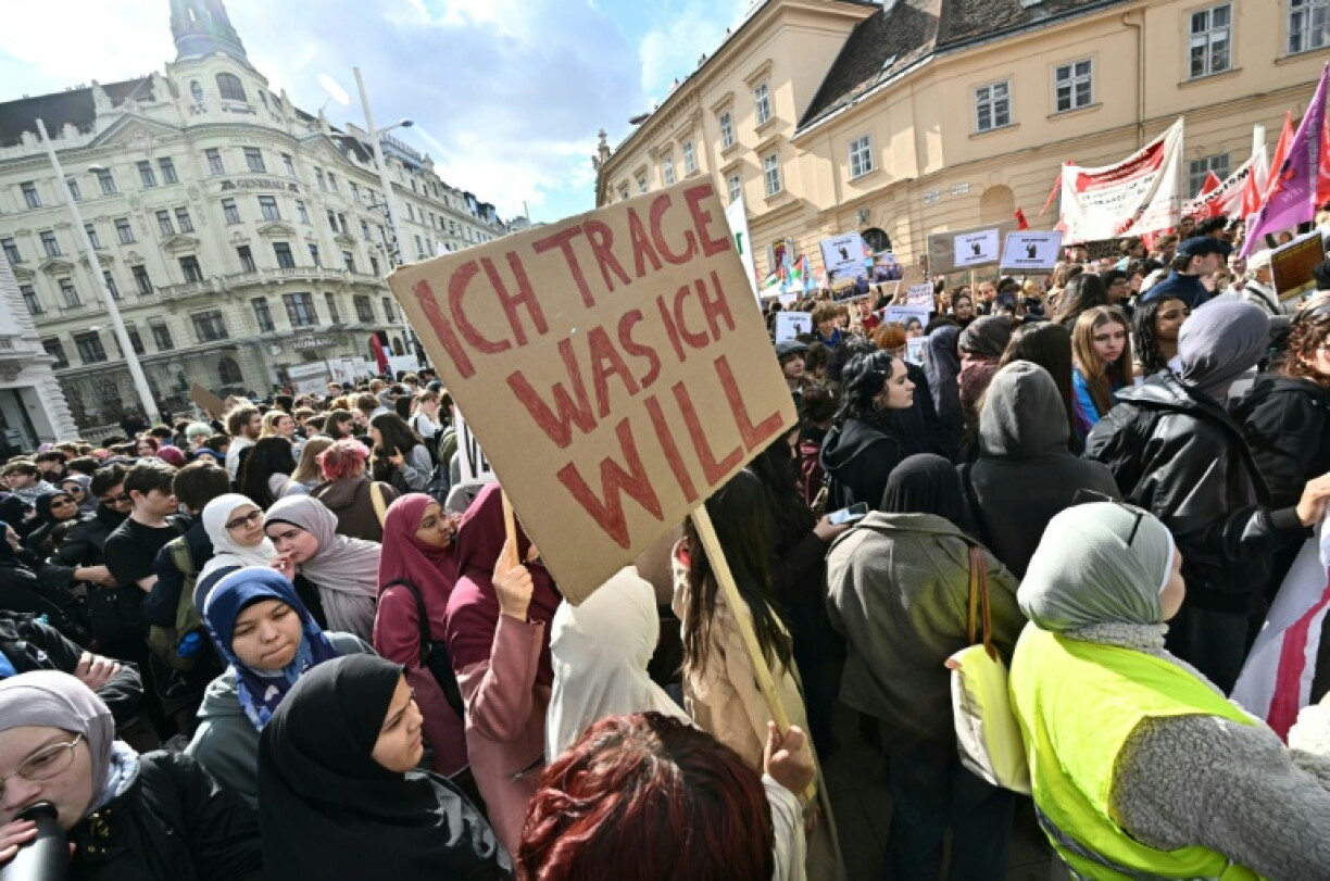 A protester holds a placard reading 'I wear what I want' during a demonstration against a headscarf ban in schools in Austria