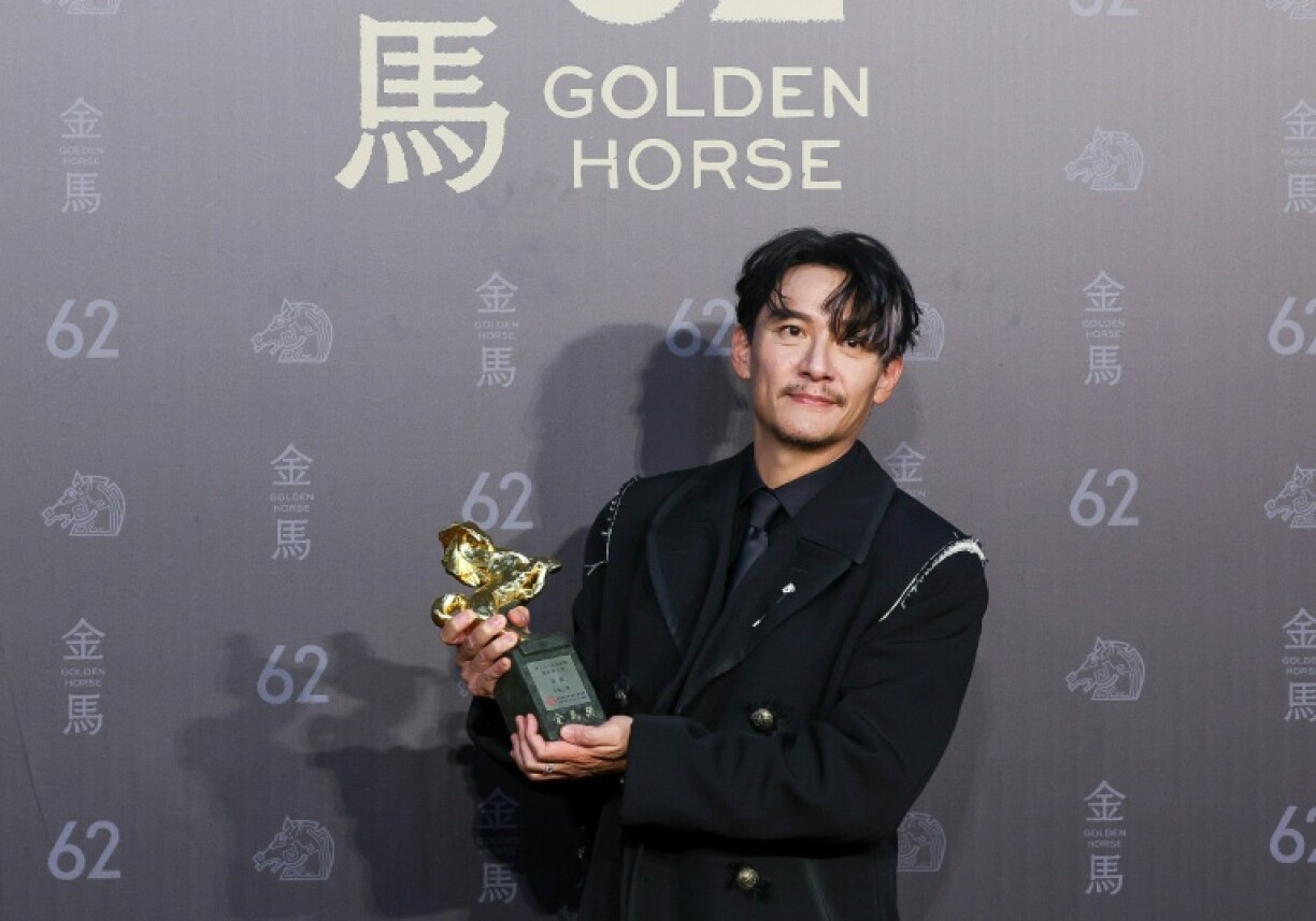 Taiwanese actor Chang Chen poses after winning best leading actor for the his role in 'Lucky Lu'