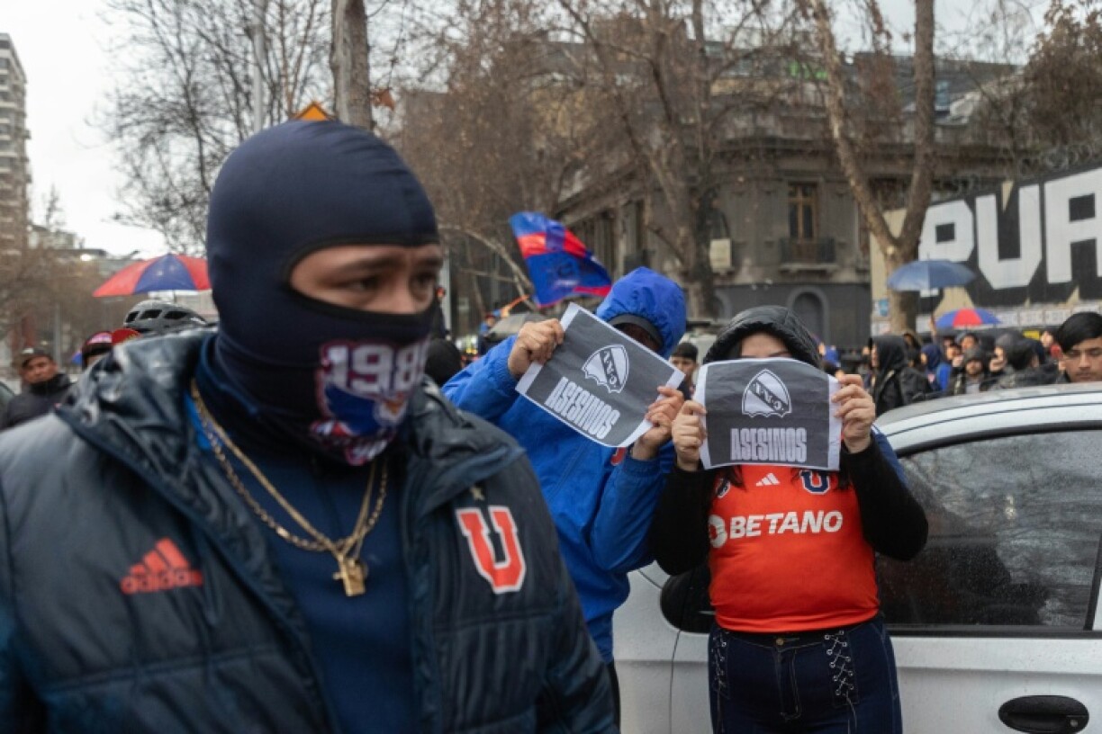 Universidad de Chile fans protest outside Argentina's embassy in Santiago, demanding the release of Chileans detained after the violence