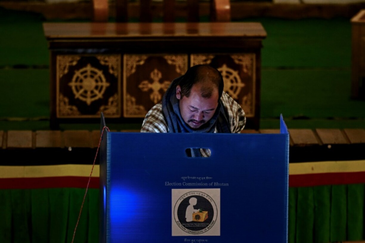 A voter casts his ballot at a polling station during Bhutan's general elections in January 2024