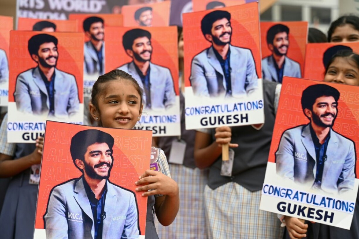 Indian school students congratulate the world's youngest chess champion Gukesh Dommaraju, in Chennai