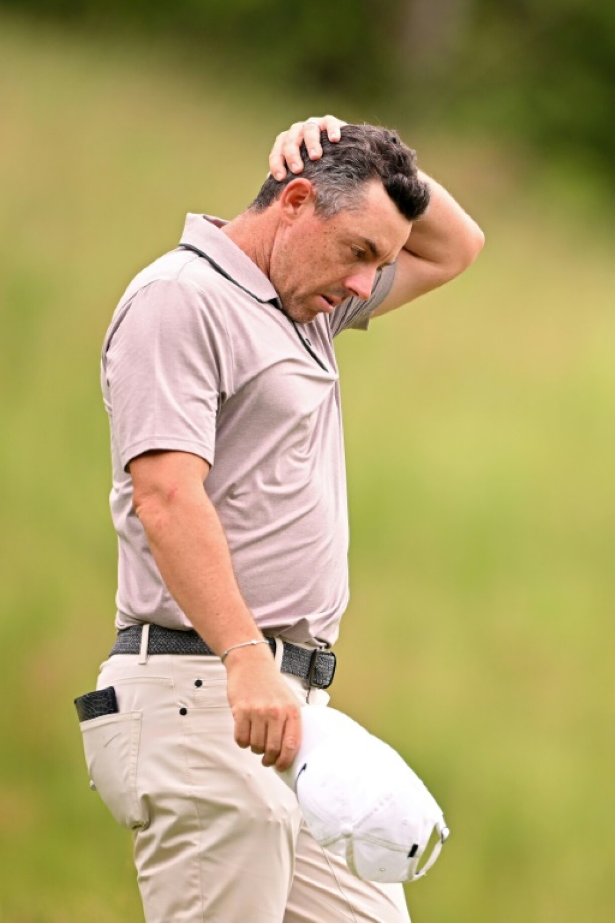 Second-ranked Rory McIlroy of Northern Ireland wipes his head during the third round of the US Open at Oakmont