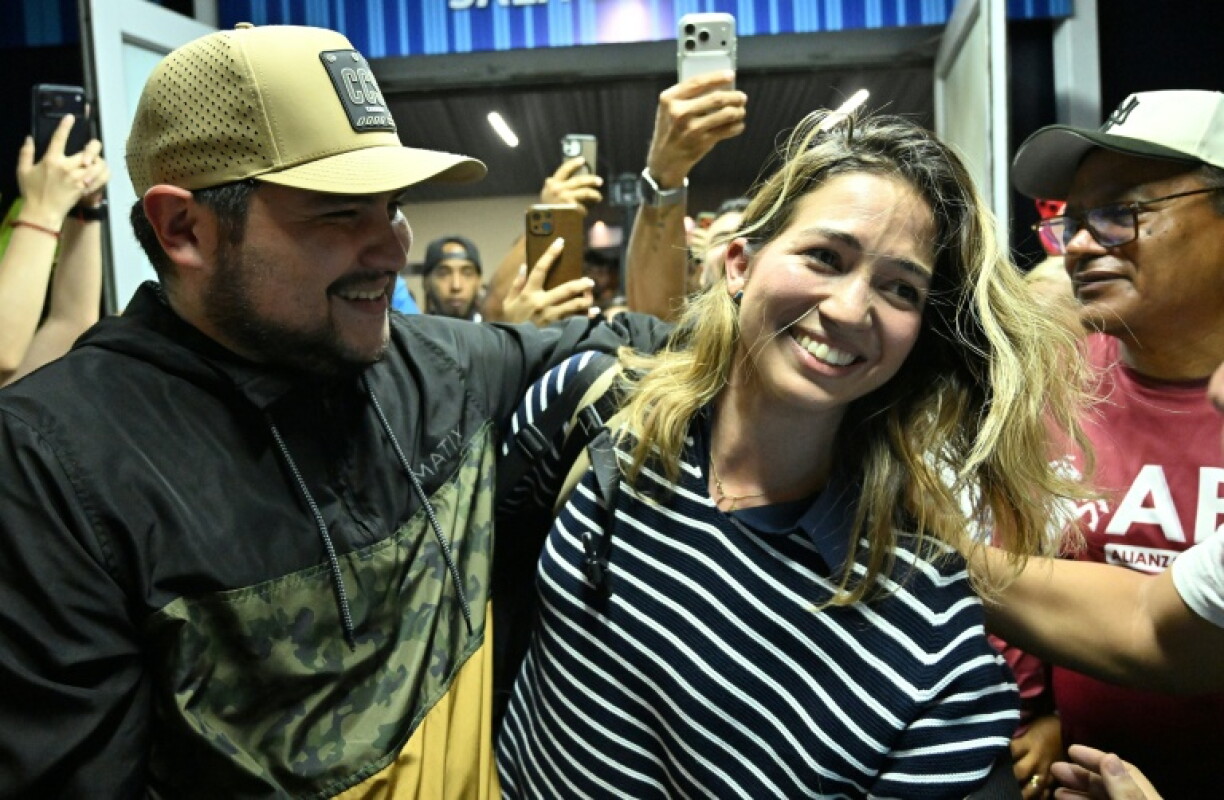 Opposition figure Claudia Macero was welcomed by relatives after returning to Venezuela from exile
