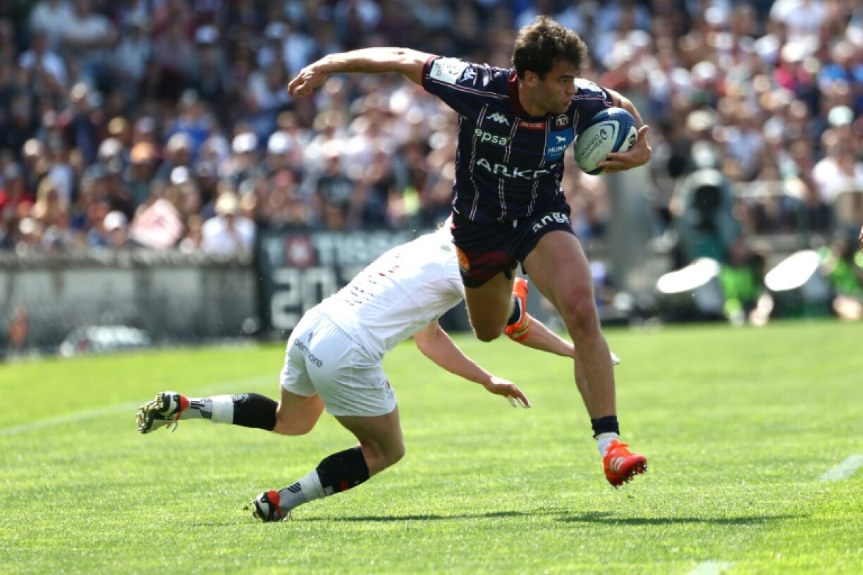 Bordeaux's Damian Penaud tackled by Ulster's Michael Lowry