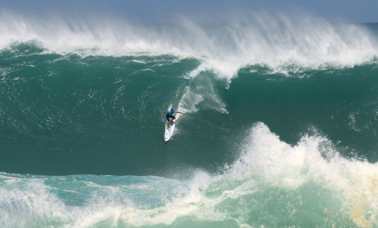 Jeremy Flores with his 'back to the wall' at Waimea Bay, Hawaii in 2016