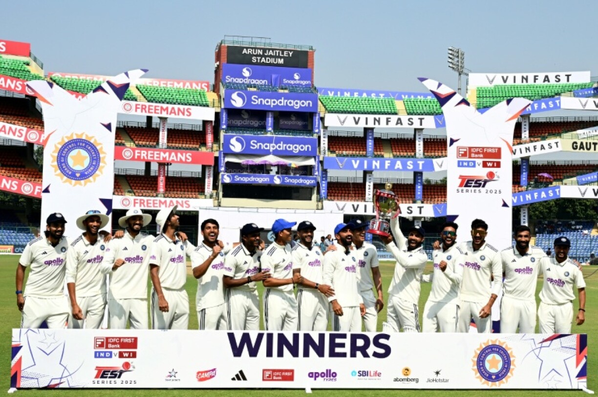India's players celebrate with the trophy after their win against West Indies