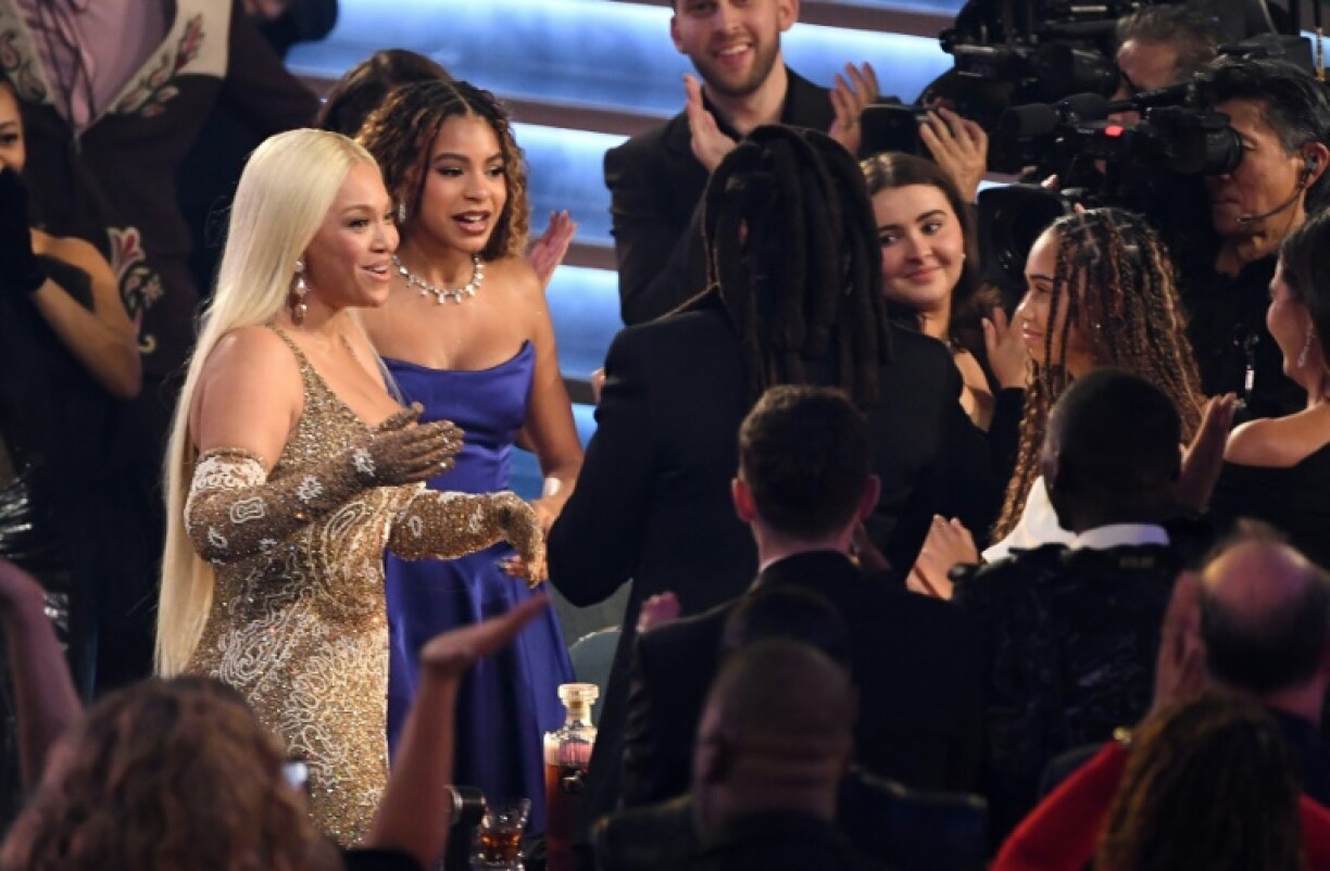 Beyonce reaches out to husband Jay-Z as she celebrates her Album of the Year win at the Grammys