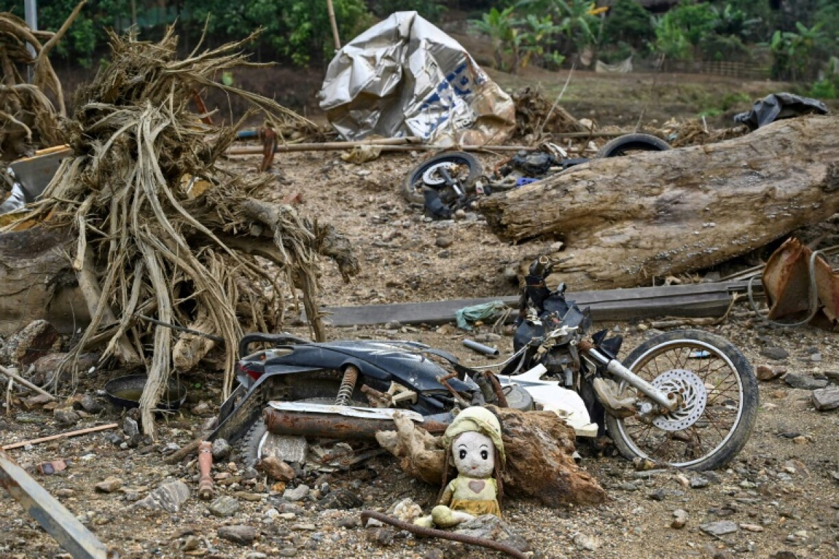 Remaining debris and items displayed at a makeshift memorial at the original site of Lang Nu village after part of it was wiped away in a landslide triggered by Typhoon Yagi's devastating heavy rains last year