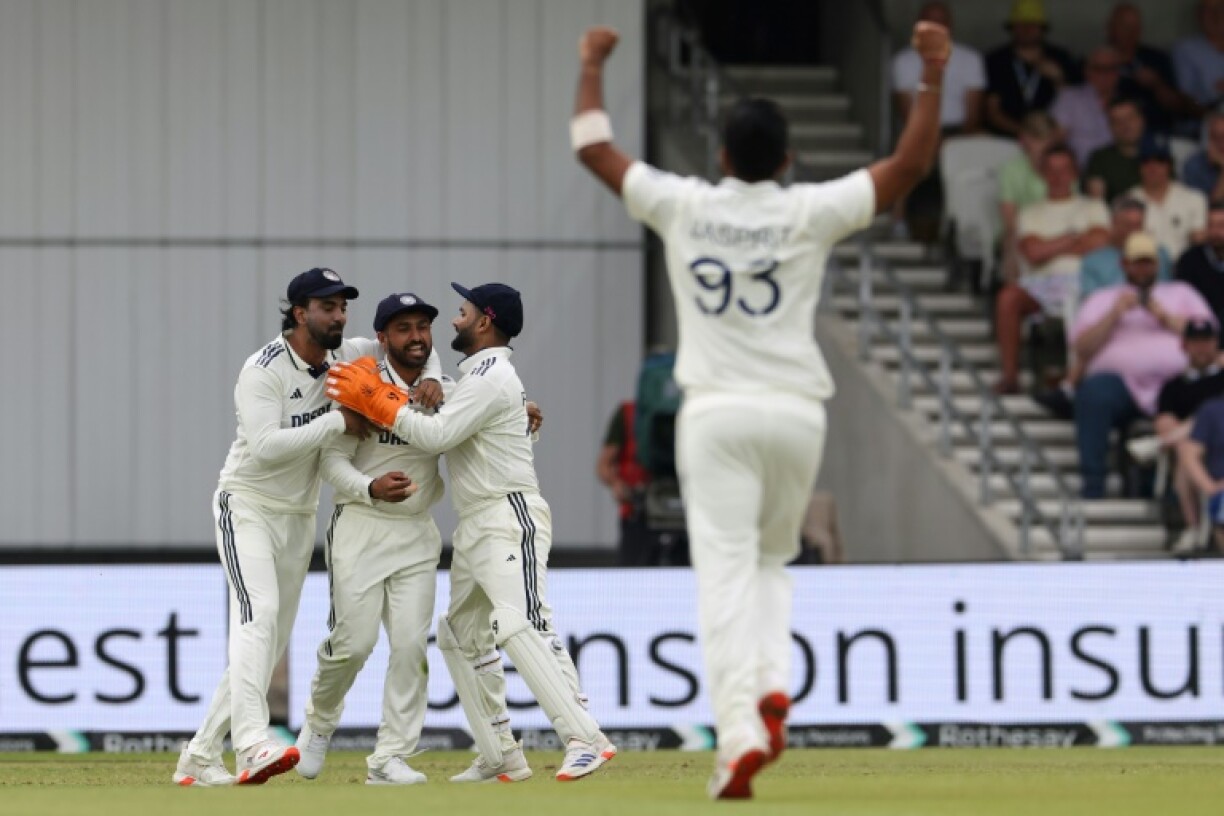 India's Karun Nair (2L) is congratulated after taking a catch to dismiss England's Zak Crawley off the bowling of Jasprit Bumrah (R) in the first Test at Headingley