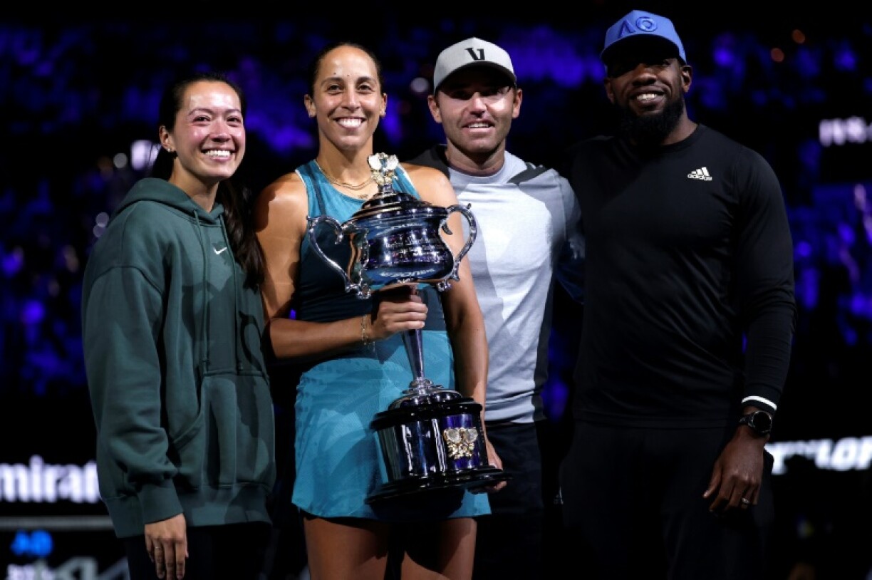 Madison Keys stands alongside husband and coach Bjorn Fratangelo with her team after lifting the Australian Open trophy