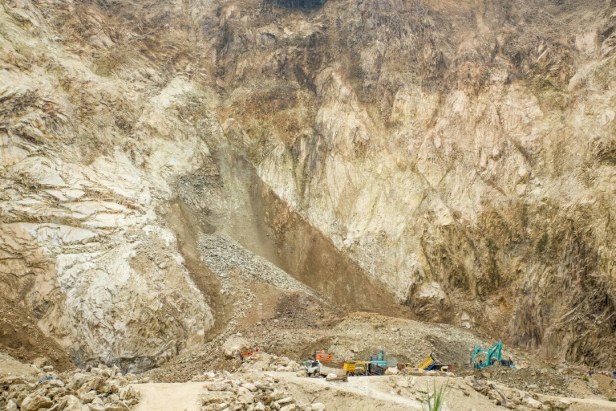 Rescuers use heavy equipment to search for people buried by a rockfall at the quarry in Cirebon, Indonesia