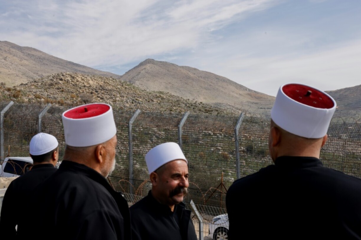 Druze are seen in the village of Majdal Shams, in the Israeli-annexed Golan Heights, as they wait for the arrival of a delegation from the Syrian side of the Golan