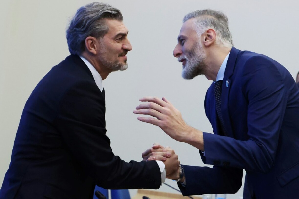 Georgian Dream says it will install former footballer Mikheil Kavelashvili (L) as president