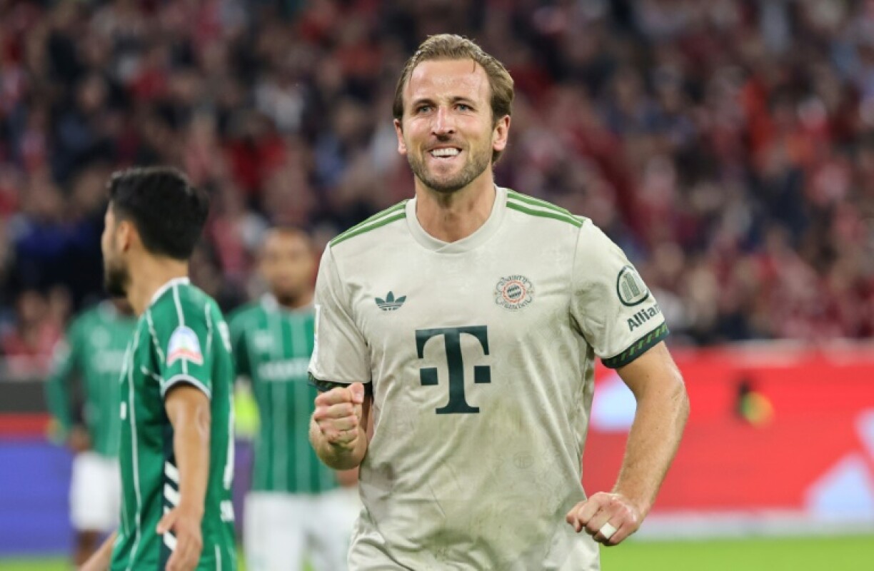 Bayern Munich's English forward Harry Kane celebrates scoring his 100th goal for the Bundesliga giants