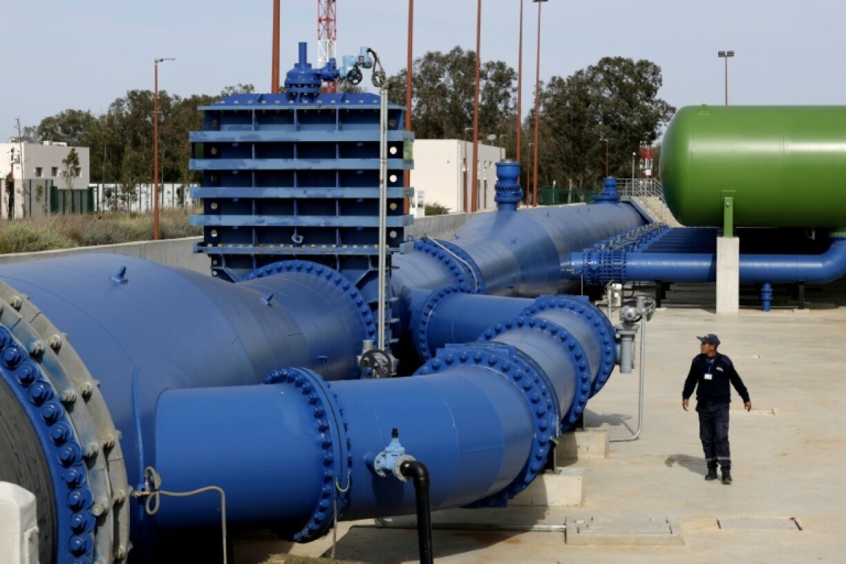 A security guard patrols the pipes at the pumping station which taps the surplus flow of the Sebou River