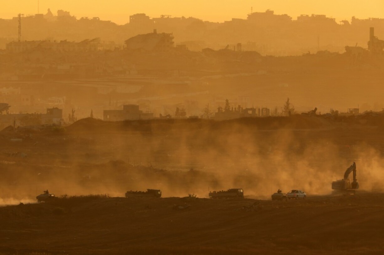 This picture taken from a position at Israel's border with the Gaza Strip shows Israelis army vehicles driving in the besieged Palestinian territory on July 8, 2025