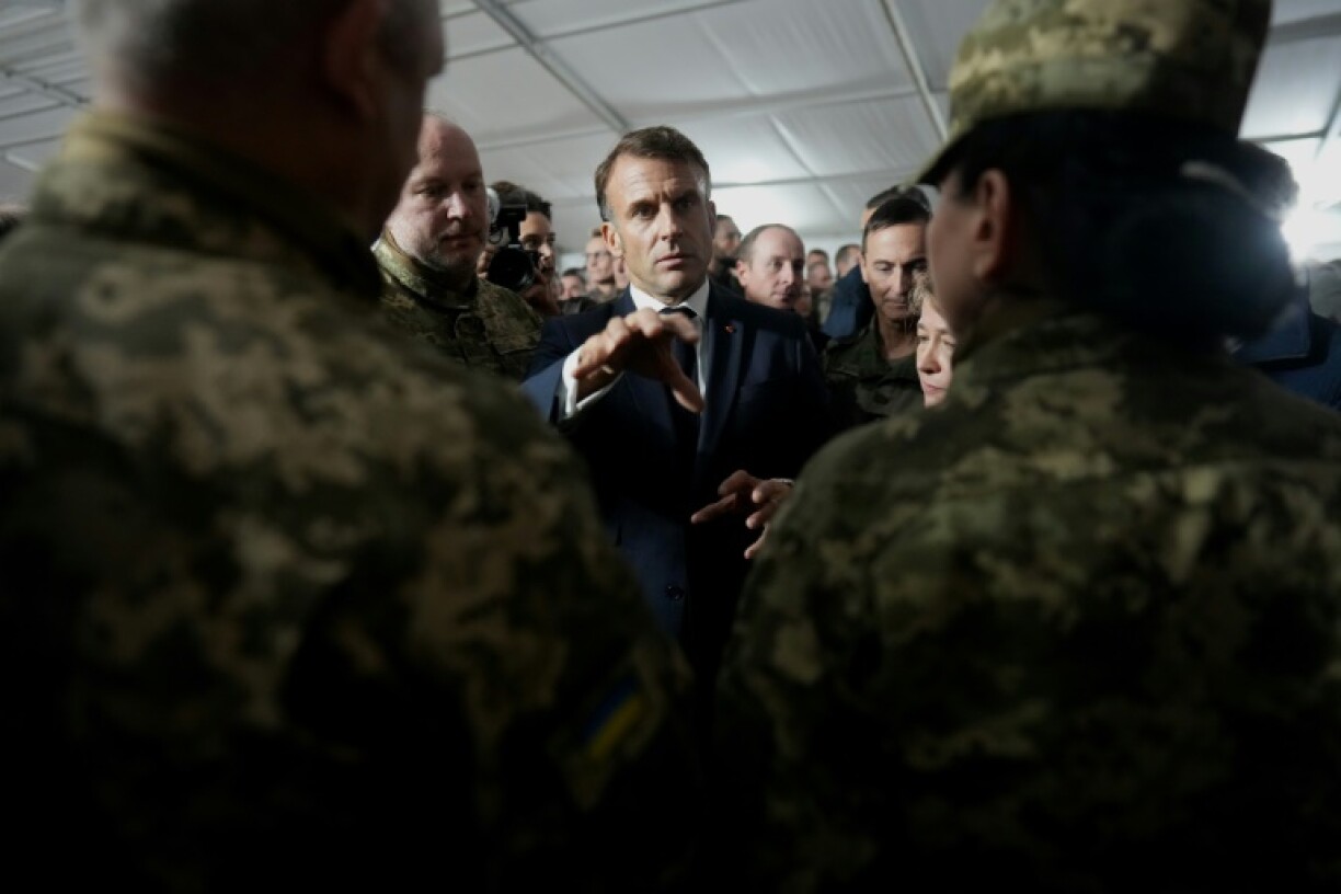 French President Emmanuel Macron speaks with Ukrainian soldiers during a visit to a military camp in eastern France in October, 2024