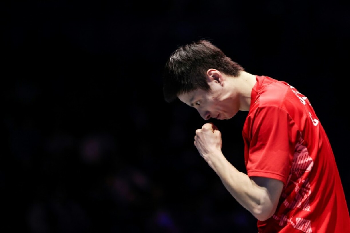 China's Shi Yuqi celebrates beating Taiwan's Lee Chia-hao to win his second title at the All England Open