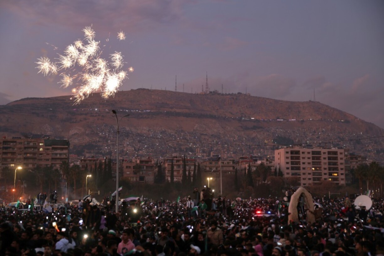 Fireworks errupt as Syrians gather to celebrate the ousting of president Bashar al-Assad at Umayyad Square in the capital Damascus, nearly two weeks after his overthrow