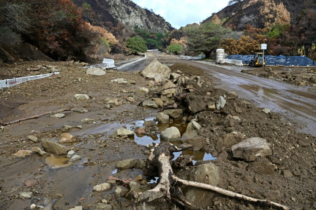 Mud and boulders have washed onto roads in the Palisades Fire burn scar after heavy rain raked the area