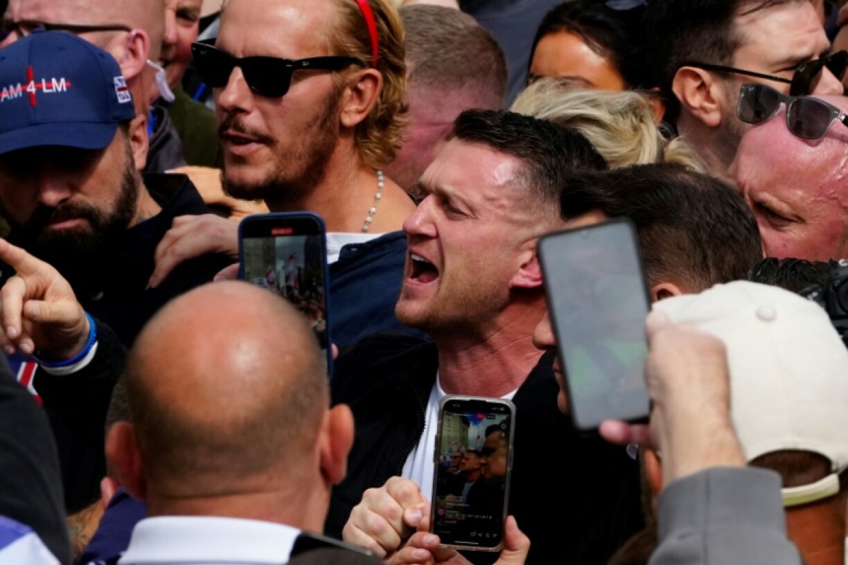 British far-right activist Tommy Robinson (C), called for Saturday's march and rally