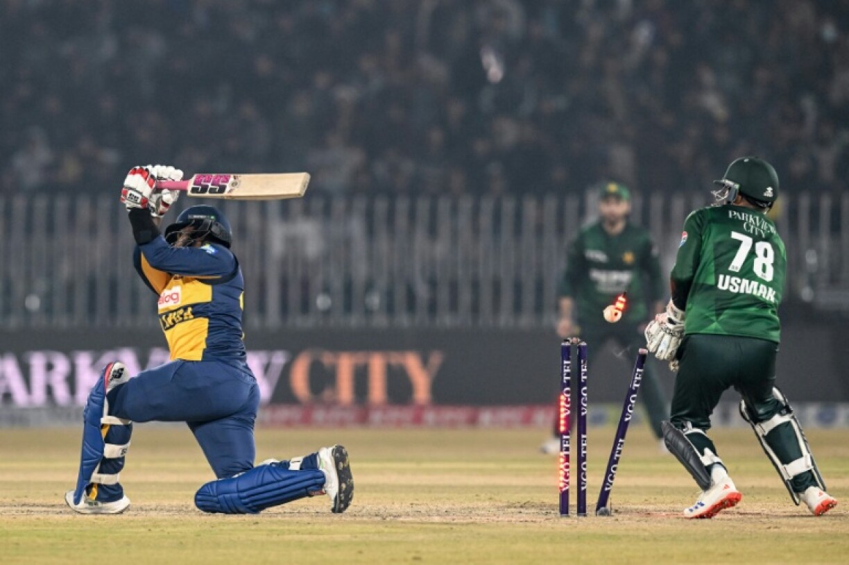 Sri Lanka's Wanindu Hasaranga (L) is clean bowled by Pakistan's Mohammad Nawaz