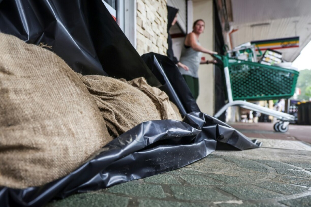 Sandbags protect a shop in the city of Lismore as a rare tropical cyclone veers towards Australia's densely populated eastern coast.