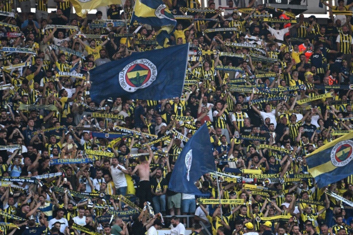 Fenerbahce fans cheer for their team during the UEFA Champions League 3rd round second leg football match against Feyenoord in Istanbul on August 12, 2025