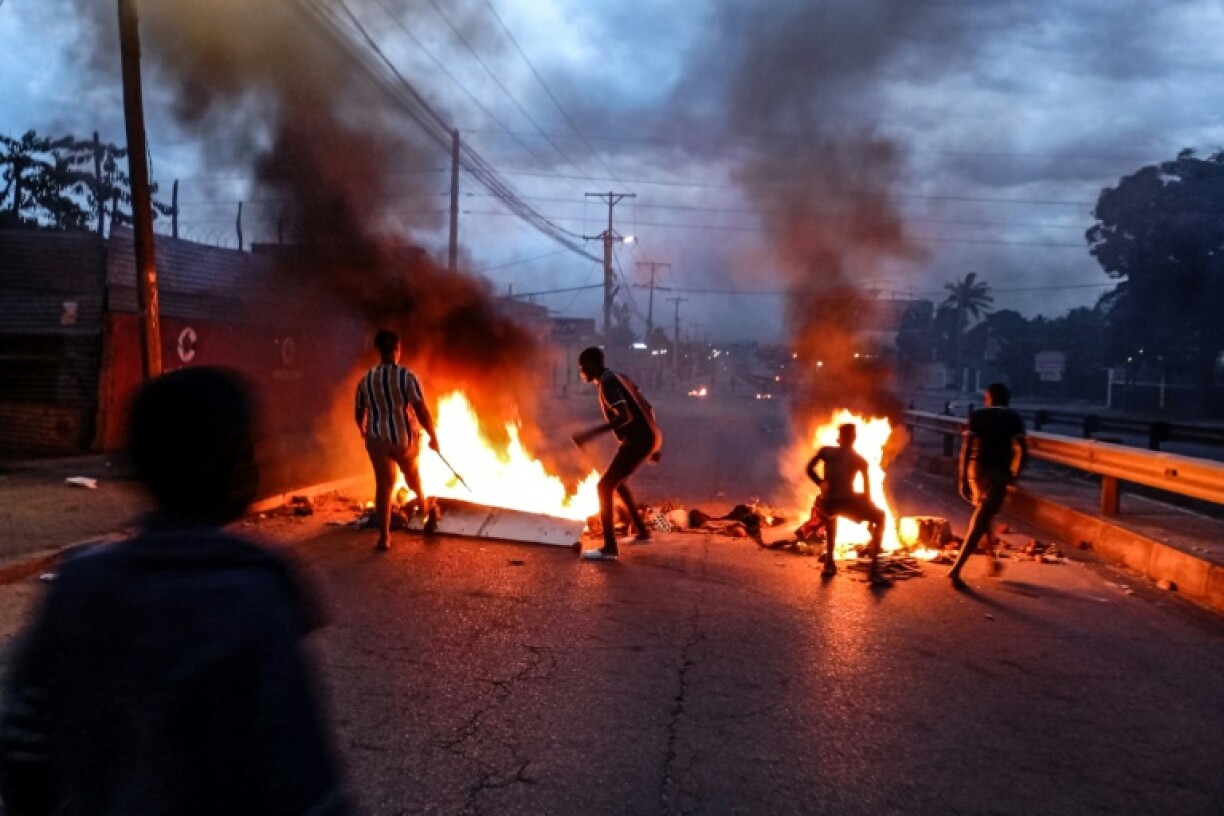 Protesters gathered next to a burning barricade in Maputo on Monday after the victory of the long-ruling Frelimo party was confirmed