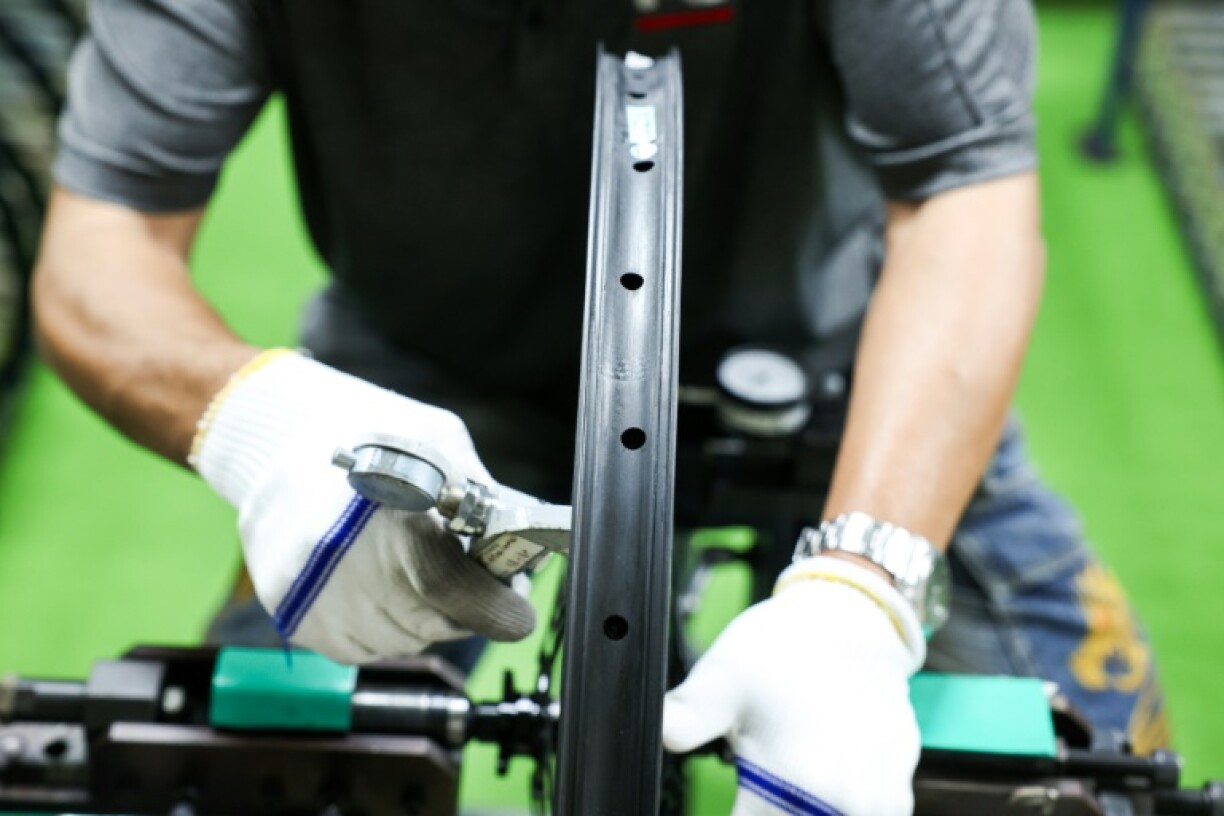A worker tests a bicycle wheel at a factory of Joy Group in Taichung on April 24, 2025