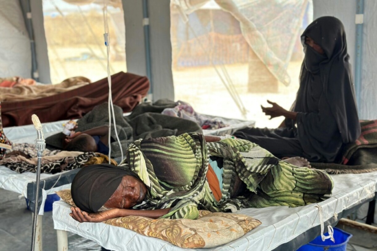 Cholera patients receive treatment in an isolation tent in a displaced persons' camp in Sudan's war-torn western region of Darfur