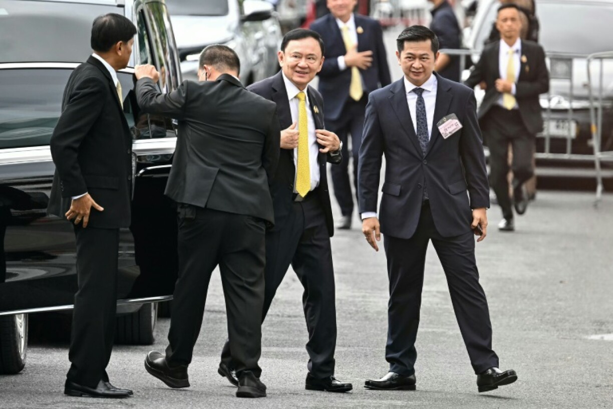 Thailand's Supreme Court said ex-premier Thaksin Shinawatra (C) must serve a year in jail after finding his stay in hospital did not count as time served