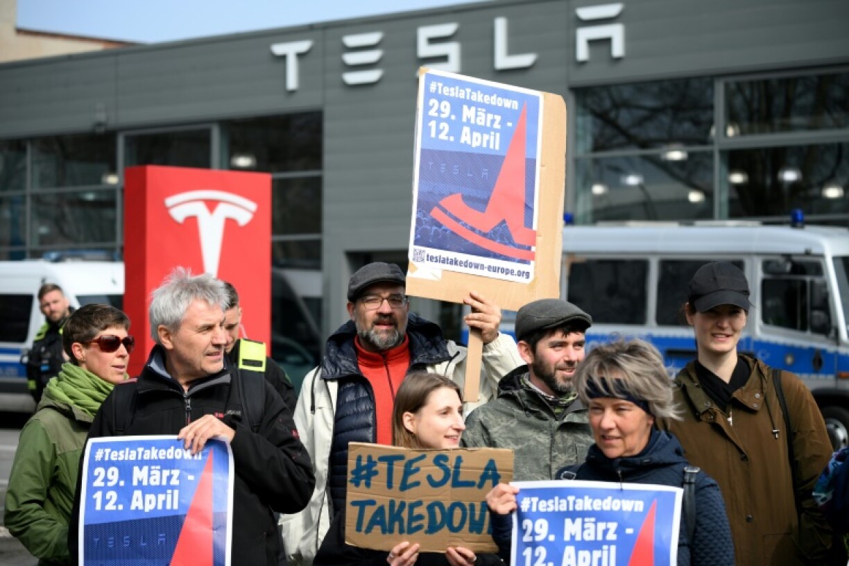 Demonstrators protest at a Tesla service centre in Berlin