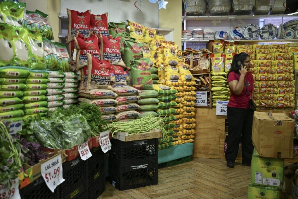 A person stands in a supermarket in the ‘Little India’ neighborhood of New York City
