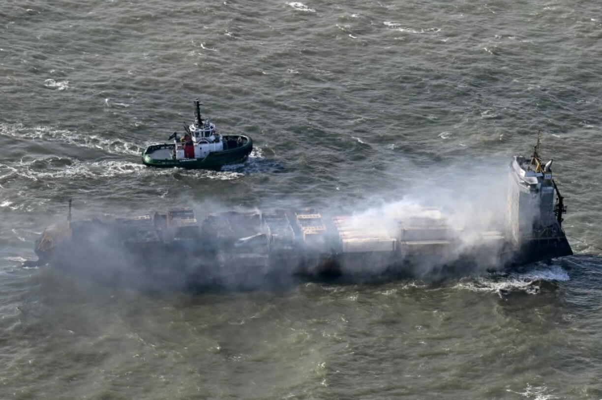 A tug boat accompanies the stricken Solong cargo ship following a devastating collision in the North Sea off the Yorkshire coast