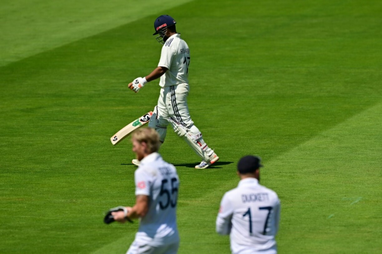 Rishabh Pant walks back to the pavilion after being run out for 74 by England captain Ben Stokes (L) during India's first innings in the third Test at Lord's